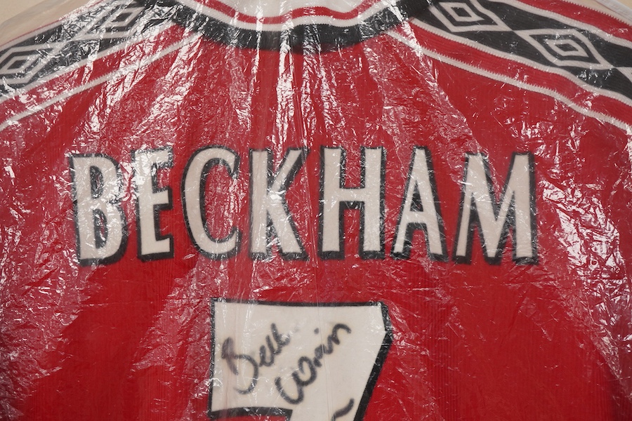 A Manchester United Umbro Sharp polo shirt, signed by David Beckham